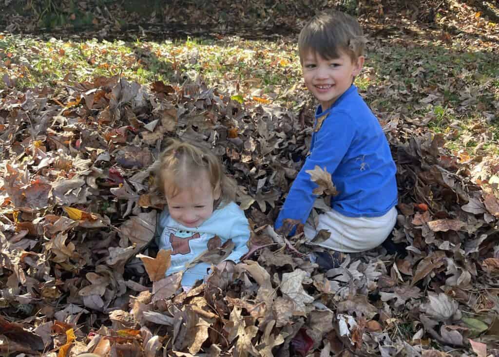 Playing in the fall leaves for your fall family bucket list | Everyday She Moms