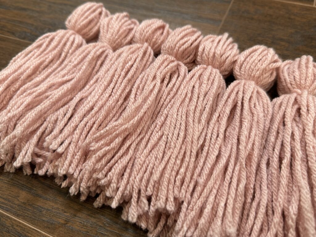 set of pink yarn tassel for example