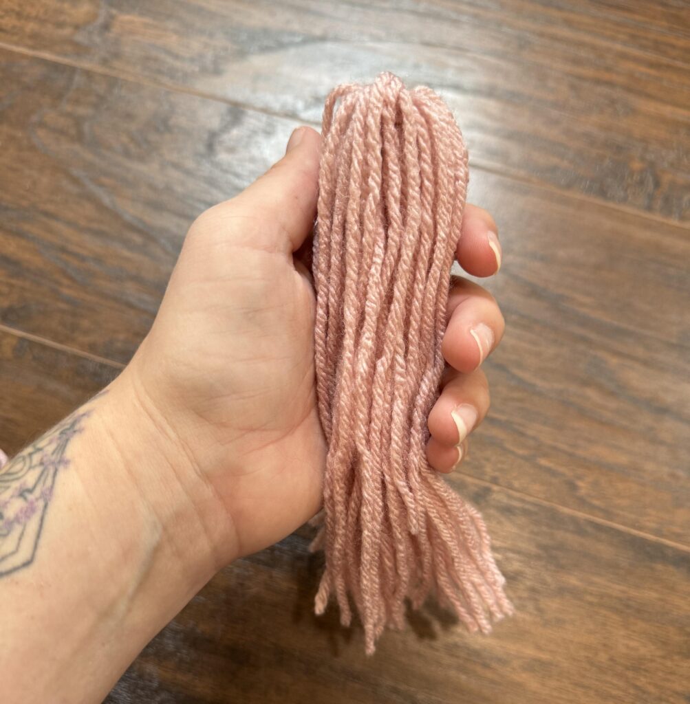 fold over the yarn to create the final look of your yarn tassel