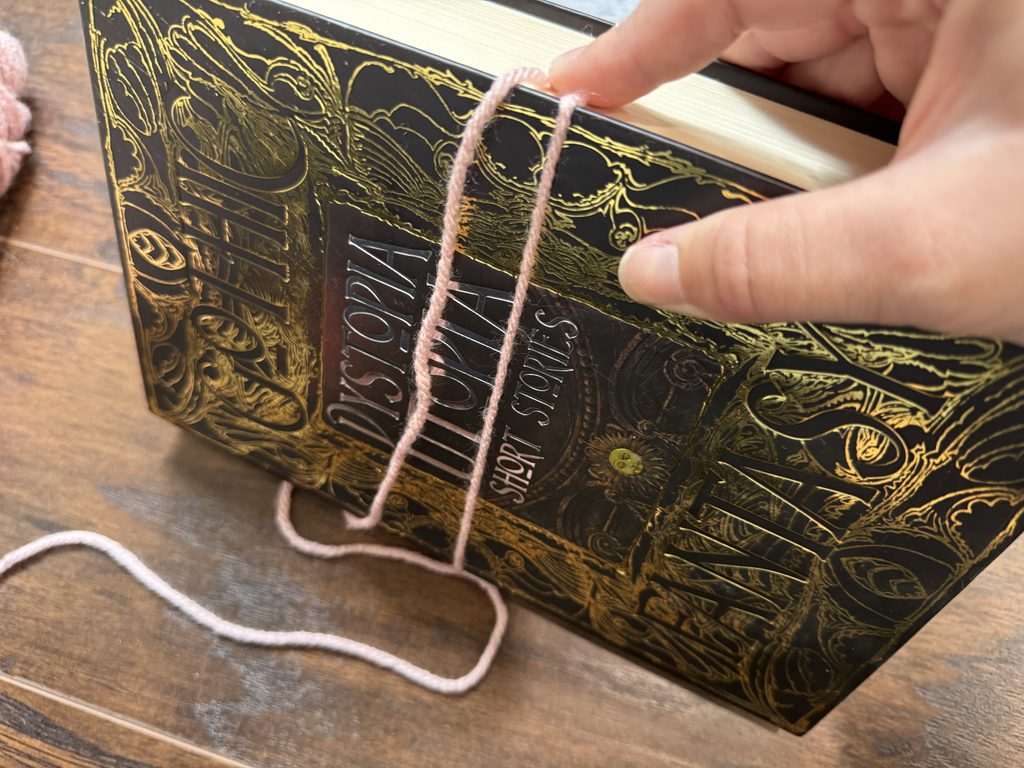 wrapping the first round of yarn to create yarn tassel