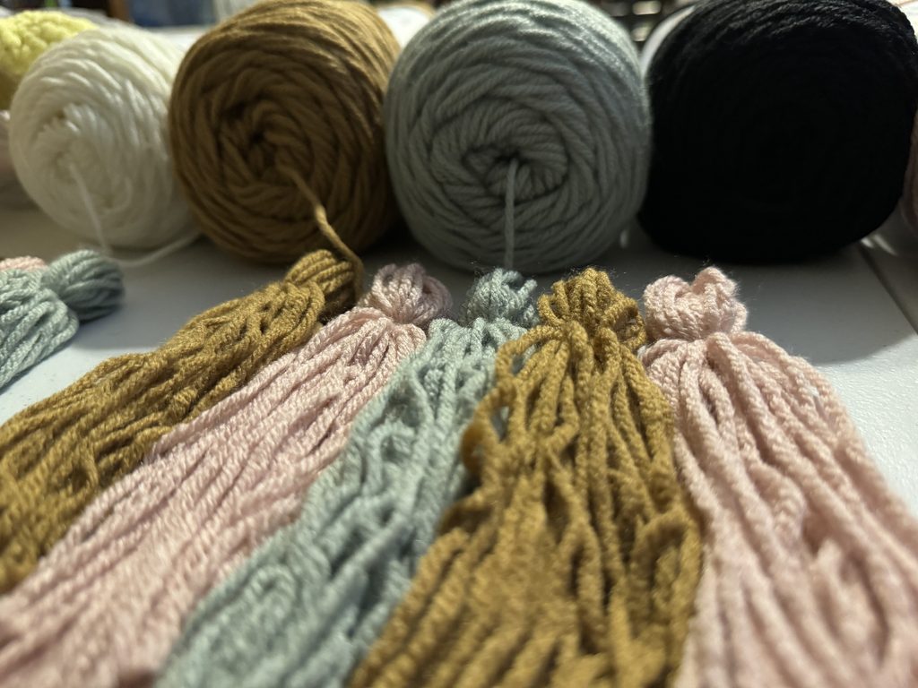 different yarn colors to create yarn tassels for birthday banner